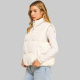 Side view of a woman wearing a textured white puffer vest