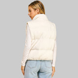 Back view of a woman wearing a textured white puffer vest