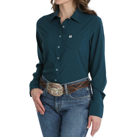 Model wearing a Cinch Women's Solid Teal Long Sleeve Button Up Shirt