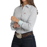Side view of a woman wearing a white striped western shirt with long sleeves and a chest pocket.