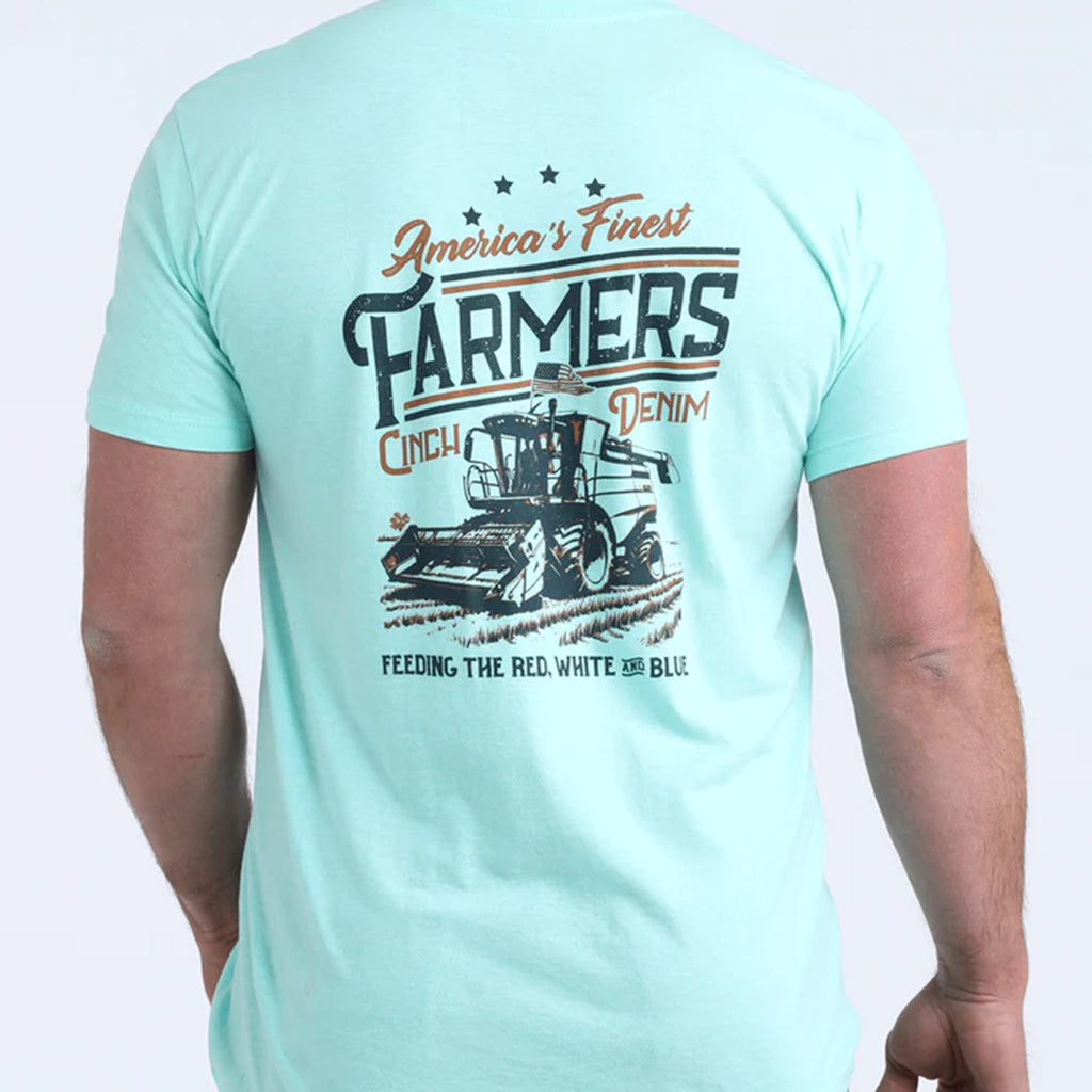 Back side view of teal t-shirt with large "America's Finest Farmers" motif that features a combine. 