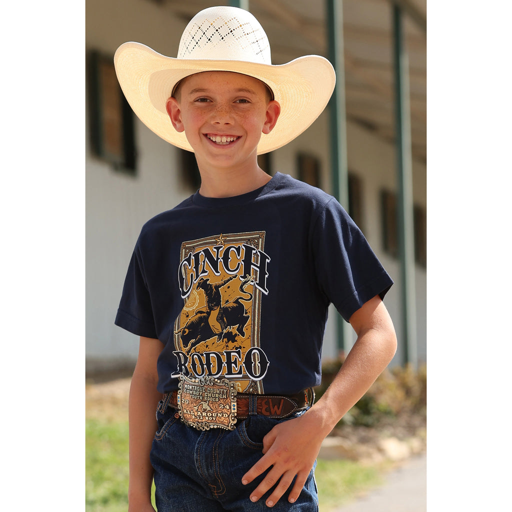 Youth wearing the Navy Cinch Rodeo Tee, front view showing the bold bull‑rider graphic and classic crew‑neck fit