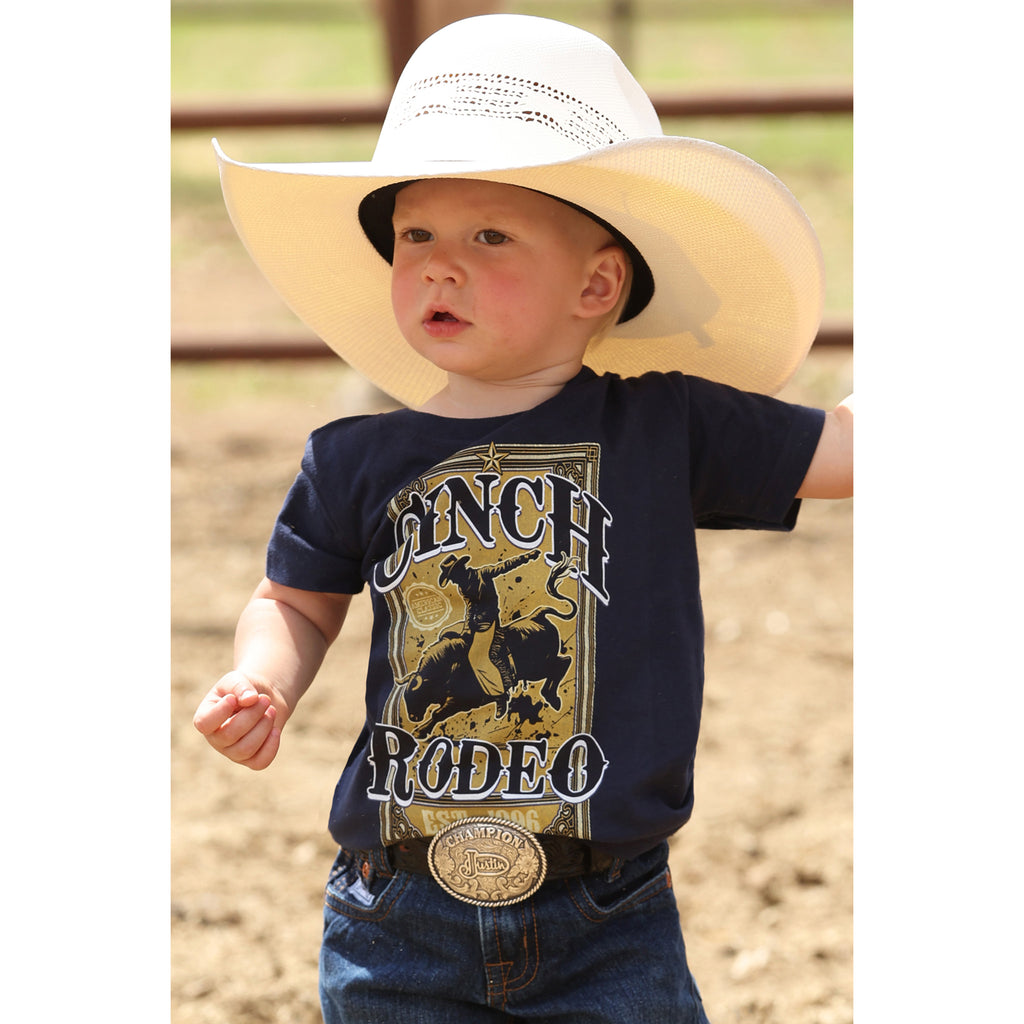 Toddler wearing the Navy Cinch Rodeo Tee, front view showing the bold bull‑rider graphic and classic crew‑neck fit 
