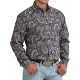Angled view of model in the Cinch Men’s Paisley Long Sleeve Teal Shirt highlighting the sleeve length, tailored silhouette, and detailed paisley print.