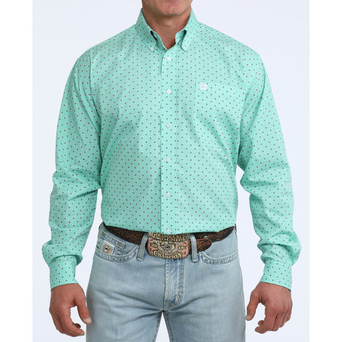Man wearing turquoise long sleeve shirt with grey diamond pattern.