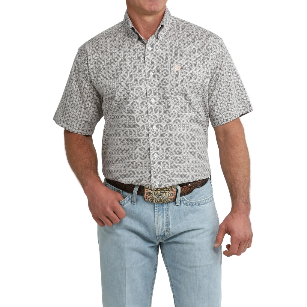 Model wearing the Cinch Men’s Grey and White Geo Print Short Sleeve Shirt, showing the bold geometric pattern and classic Western fit.