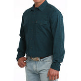 Side view of model in Cinch Men’s Teal Paisley Shirt, highlighting sleeve detail, tailored silhouette, and teal paisley design.

