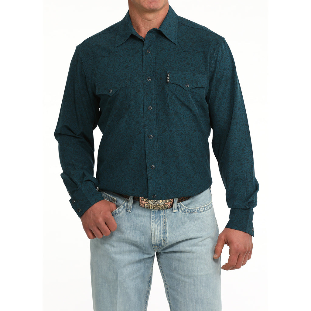 Model wearing the Cinch Men’s Teal Paisley Long Sleeve Shirt, showing the paisley print and classic Western snap closure fit.