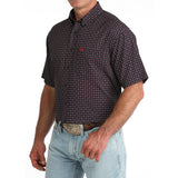 Side view of model in the Cinch Navy Geo Print Short Sleeve Shirt highlighting the sleeve length, tailored silhouette, and detailed geo print.