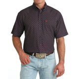 Model wearing the Cinch Navy Geo Print Short Sleeve Shirt, front view showing the navy geometric pattern, button‑down front, and classic Western fit.