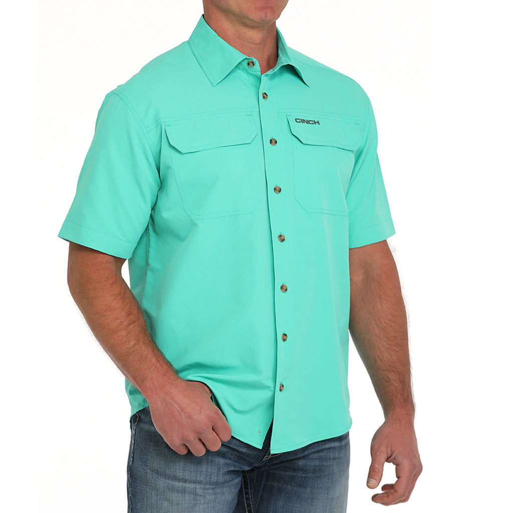 Short sleeve green sun shirt, with grey cinch logo on front pocket.