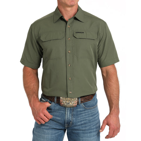 Olive Green Arena flex short sleeve, two pocket on chest, vented back 