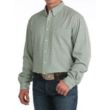 Man wearing the Cinch Green Geo Print Long Sleeve Shirt, side angle highlighting the long sleeves, tailored fit, and crisp geometric print.