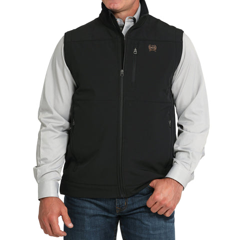 Front view of Cinch black concealed carry vest with zip closure and chest logo