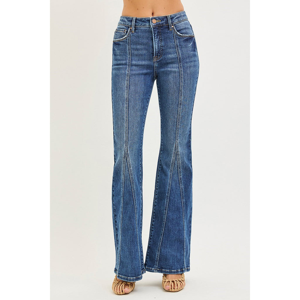 Model wearing Risen dark tummy control high rise flare jeans with front seam detail, front view showing the smoothing waistband, vertical seam, and flared leg.