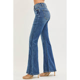 Side view of a model in Risen dark tummy control high rise flare jeans, highlighting the sculpting fit, front seam line, and dramatic flare silhouette.