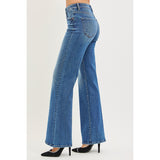 Side‑view of model wearing tummy control high rise wide flare jeans, highlighting the slimming high rise and dramatic flare shape.