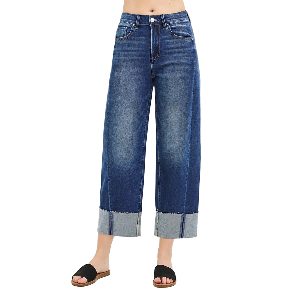 Model wearing dark slouchy barrel crop cuffed jeans, front view showing the relaxed high‑rise fit, cropped barrel leg, and clean dark‑wash finish.
