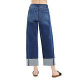 Back view of a model wearing dark slouchy barrel crop cuffed jeans, showing the shaped high‑rise fit, clean back pockets, and relaxed barrel leg.