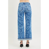 Back view of a model wearing Risen mid rise floral print straight ankle jeans, showing the clean back pockets, mid‑rise fit, and straight‑leg shape.