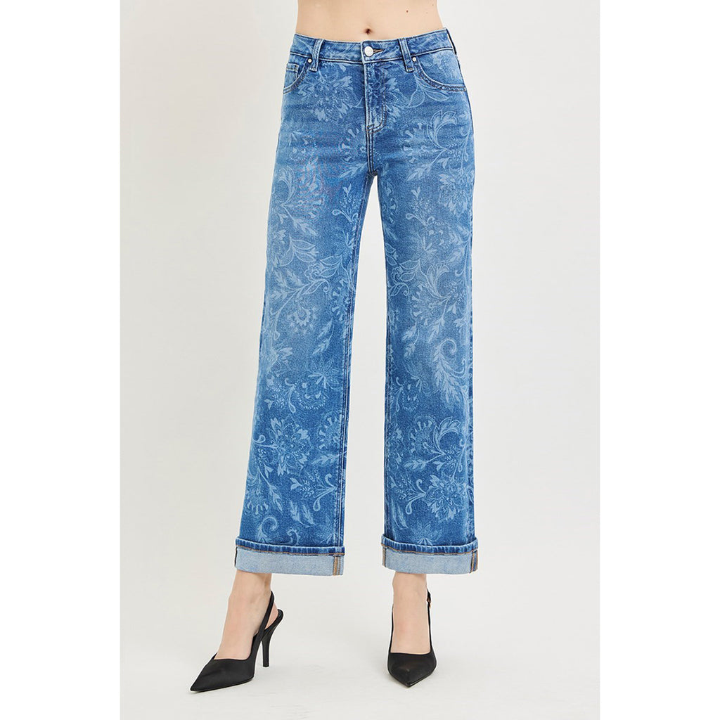 Model wearing Risen mid rise floral print straight ankle jeans, front view showing the mid‑rise fit, straight leg, and subtle floral printed detailing.