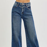 Close up of the front of the jeans, "V" sewn design under the button.