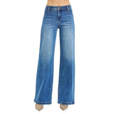 Model wearing high rise wide leg jeans with waist detail, front view showing the structured waistband, relaxed wide leg, and clean modern silhouette.