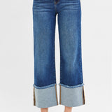 Closer view of the front of the jeans, Cuff has frayed edges.