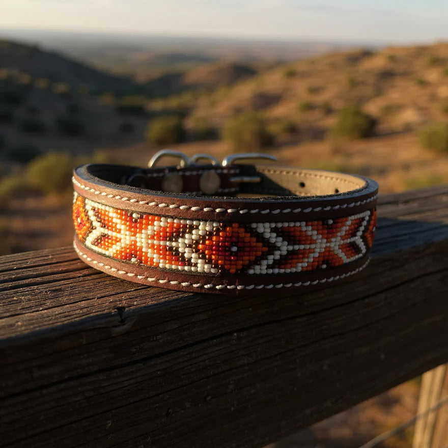 leather dog collar with maroon, white, brown, and orange beads in a geometric design. 