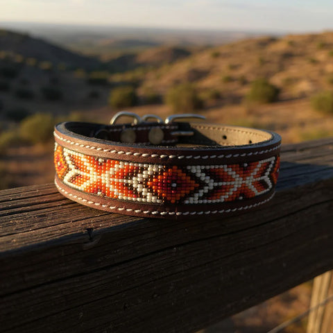 leather dog collar with maroon, white, brown, and orange beads in a geometric design. 