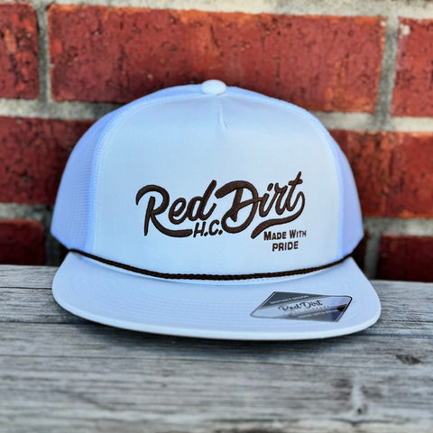 White cap with brown rope and red dirt logo.