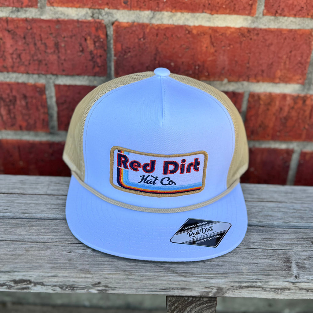 White and wheat cap with wheat colored rope and retro red dirt logo.
