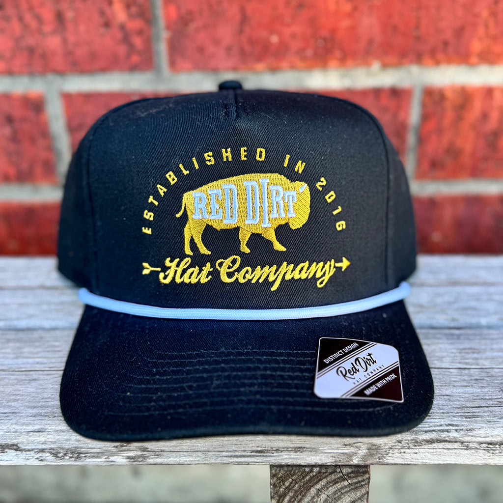 Black cap with white rope and gold red dirt buffalo logo.