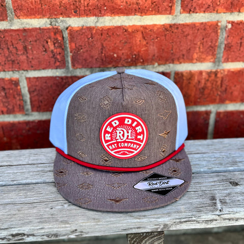 Brown and white cap with red rope that has a red red dirt logo and brown aztec accents.