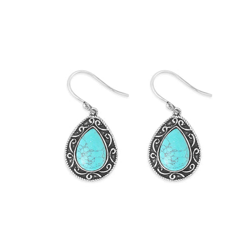 Small teardrop shaped earrings with turquoise stone in the middle and silver detailing around it. 