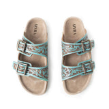 Top side view of tooled turquoise sandals.