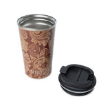 Myra Brown Baroque Leather Steel Mug with lid sitting next to it.