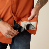 Close up of sunglasss cloth on the inside of orange shirt.