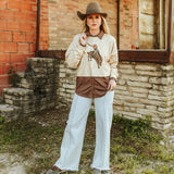 Full view of model wearing shirt. This piece just includes the sweater and not the brown under shirt.