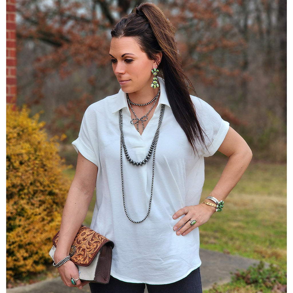 drop shoulder white v neck top with cuffed short sleeves