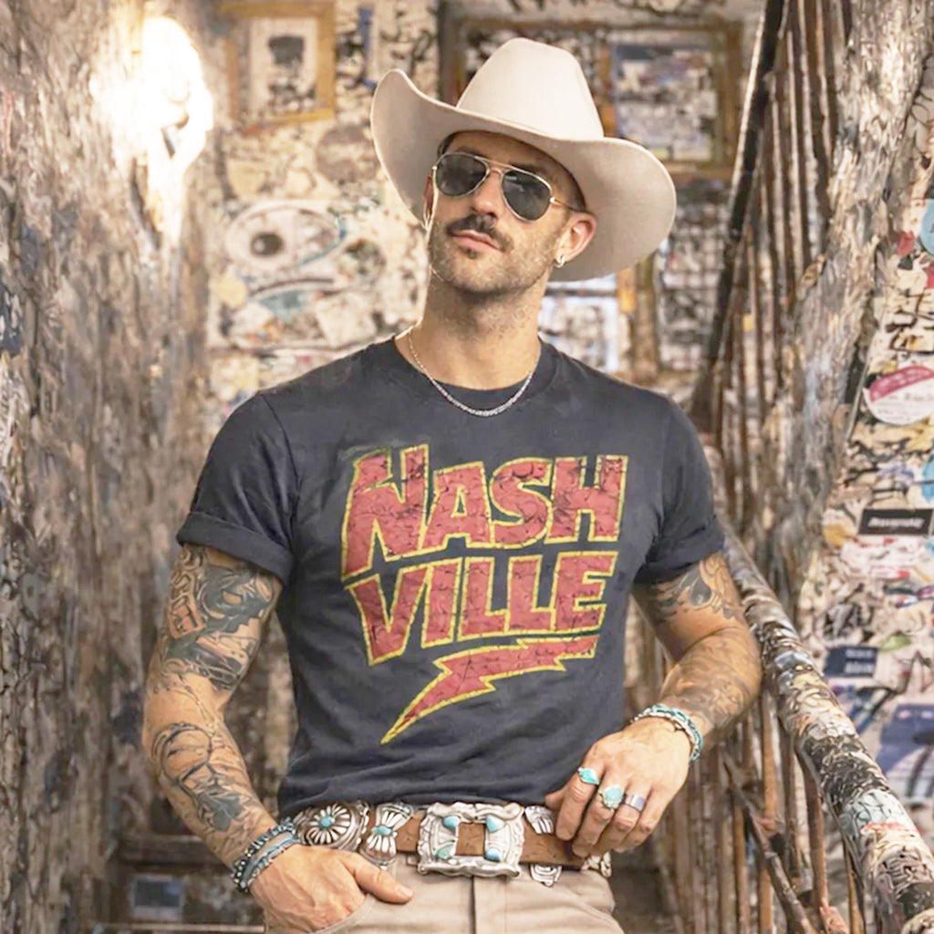 Male Model front facing wearing charcoal grey t-shirt with red and yellow NASHVILLE print. 