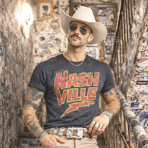 Male Model front facing wearing charcoal grey t-shirt with red and yellow NASHVILLE print. 