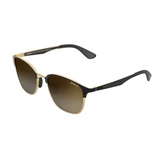 Bex Tanaya Sunglasses. They have a black and gold frame with black silver flash lenses.