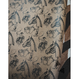 Patterned paper with illustrations of horses and riders on a textured background