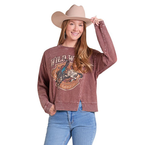 Female model wearing a burgundy Wild West crew neck sweatshirt, shown from the front to highlight the Western graphic and relaxed fit.