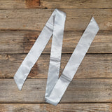 Silver/grey twilly laying flat in a "N" shape. 