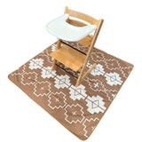 tan and white aztec splat mat with high chair on it