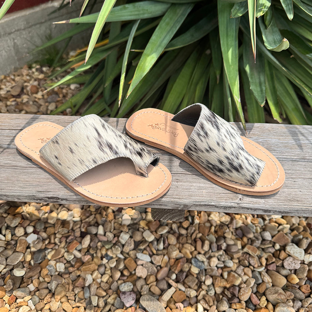 Black and white cowhide sandal with leather foot bed.