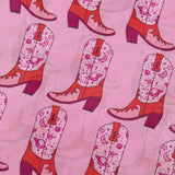 Close up view of the shirt, slightly see-through and cowboy boots have stars and planets.