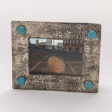 Side view of the silver photo frame showing its dimensional border and textured finish.